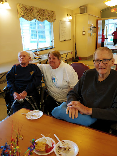 A group of elderly individuals enjoying time together in a cozy indoor setting.