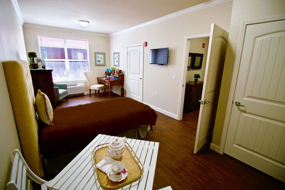 A cozy bedroom featuring warm colors, a neatly made bed, and decor that creates a welcoming atmosphere.