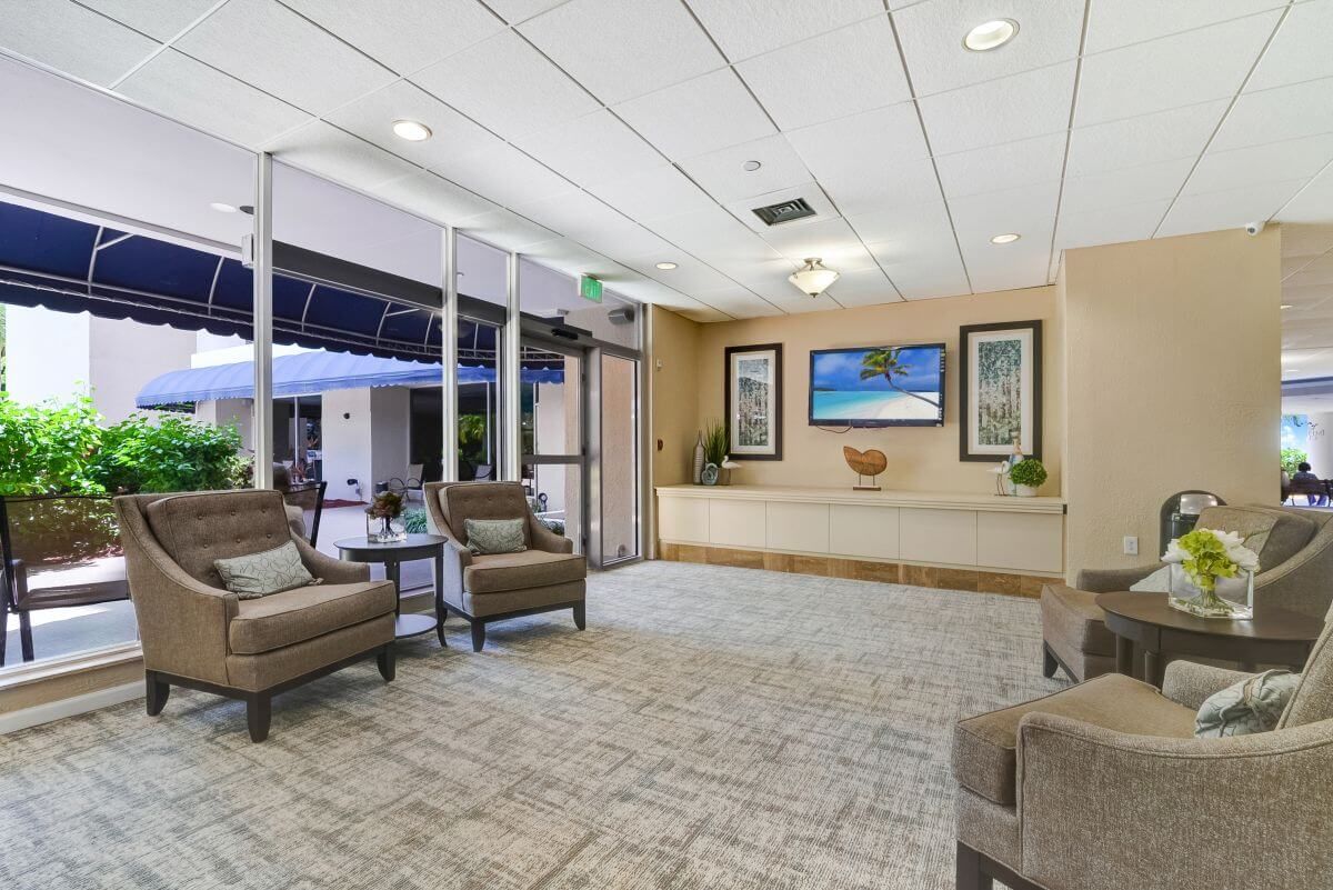 A modern lobby with comfortable seating, artwork, and indoor plants.