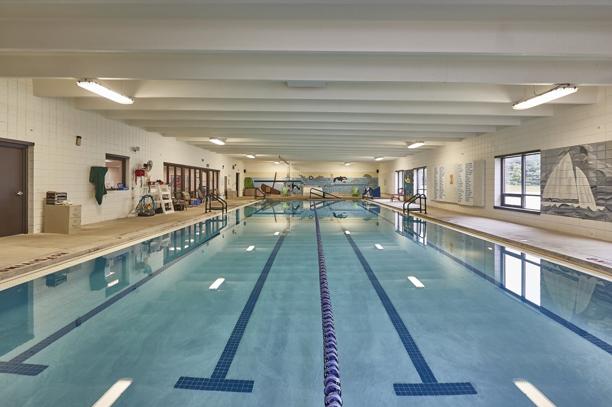 An indoor swimming pool with marked lanes and a calm atmosphere.