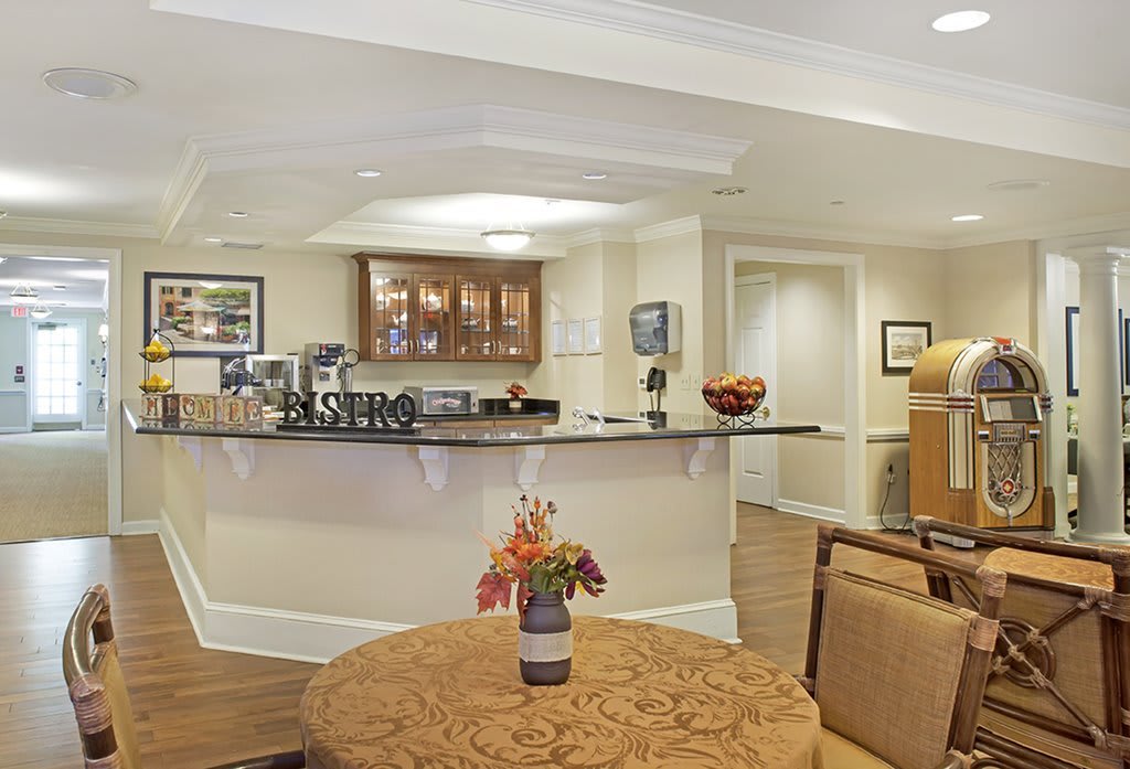A modern kitchen with a counter and cozy seating area.