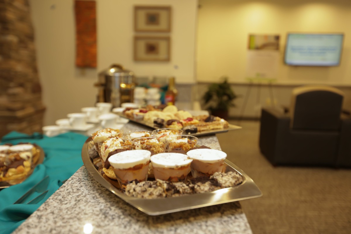 An indoor buffet setup with a variety of pastries and desserts on display.