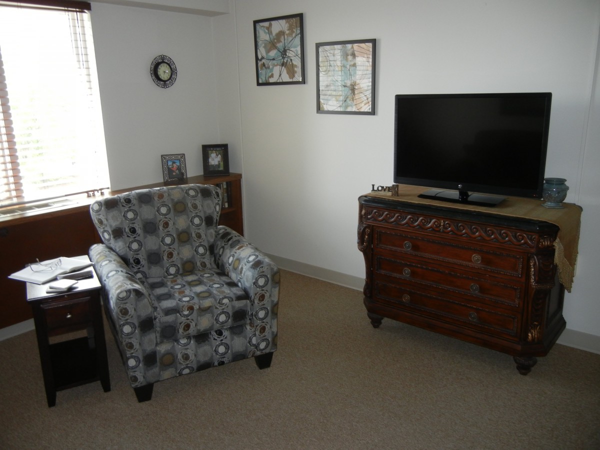 Cozy living room with an armchair and television.