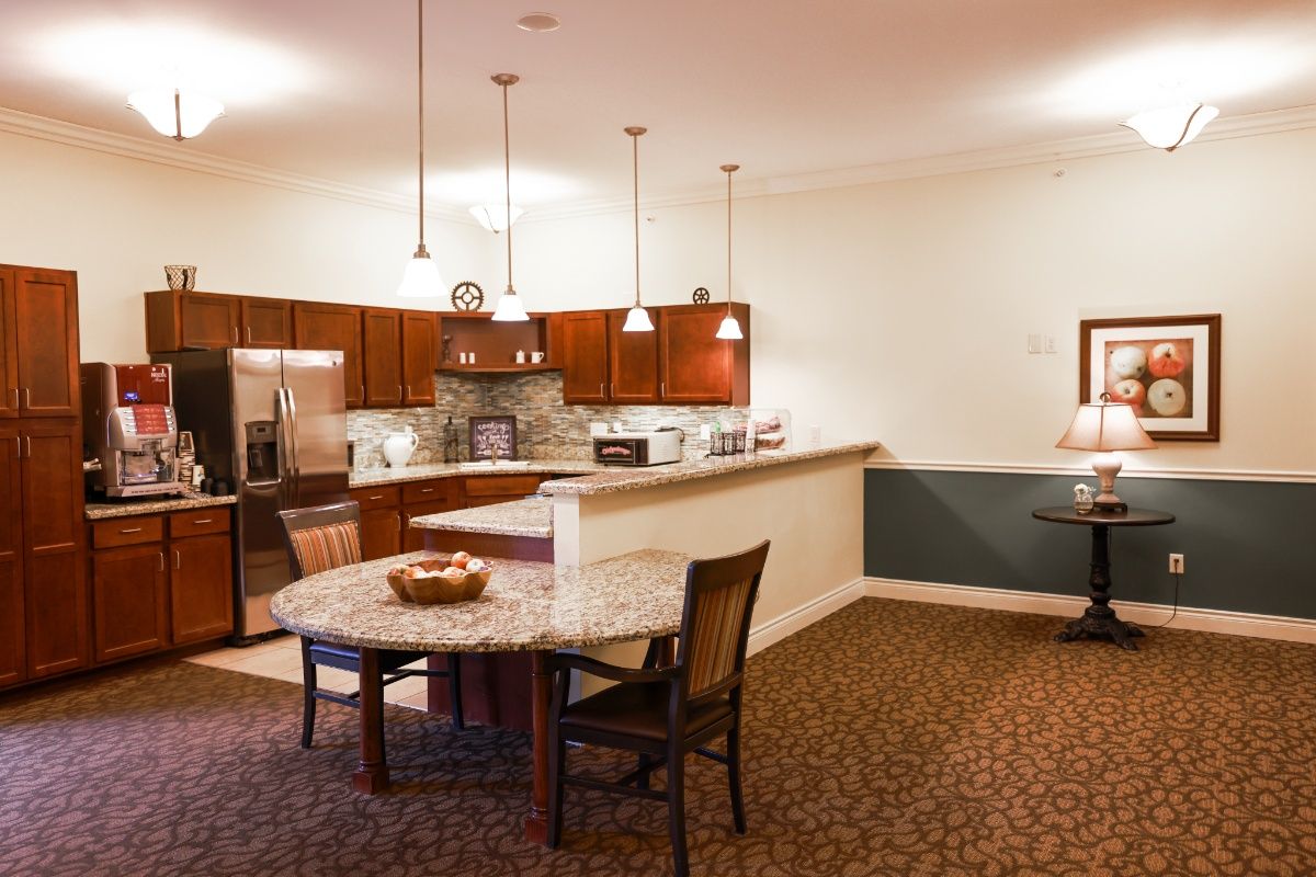 A modern kitchen and dining area with contemporary furnishings and warm lighting.