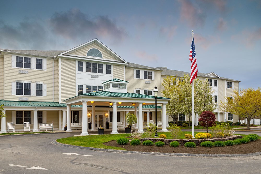 A welcoming residential building with a flagpole and well-maintained landscaping.