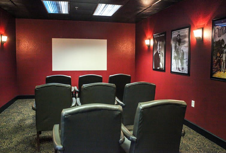 A cozy home theater setup with comfortable seating and a projector screen.