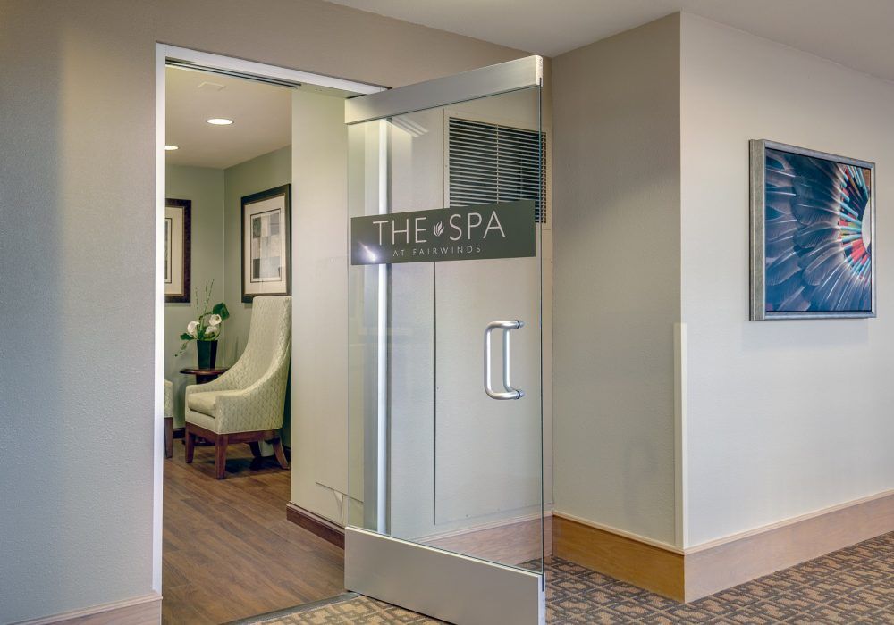 Entrance to a spa with a glass door and waiting area.