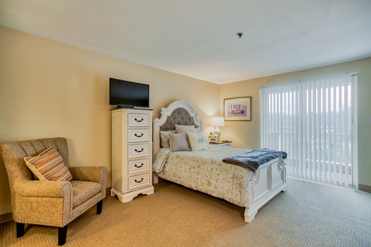 A cozy bedroom with elegant furniture and soft lighting.