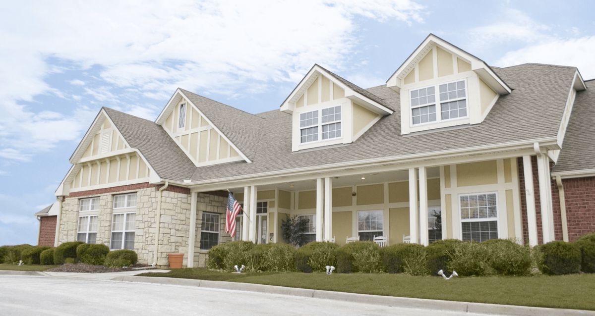 A large residential house with a porch and multiple gables.
