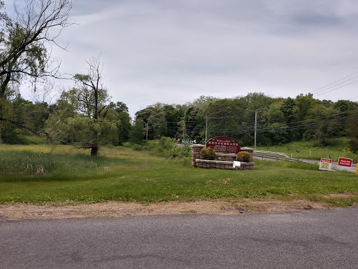 A peaceful rural scene featuring a tractor near a grassy area.