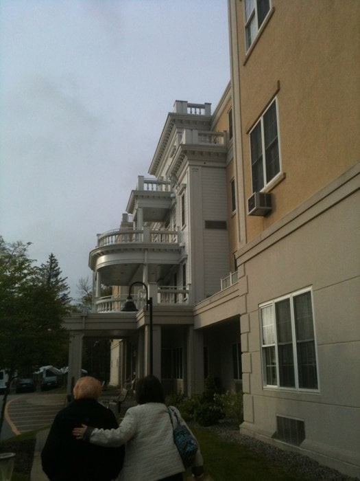 A multi-story building with prominent balconies and an urban setting.