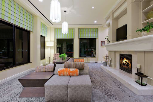 A modern living room featuring a cozy fireplace and stylish furniture.