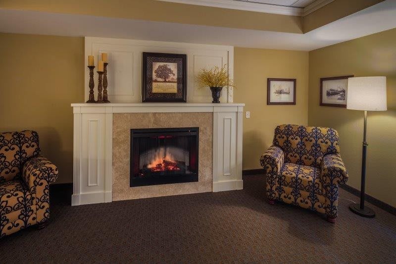 A cozy living room with a fireplace and comfortable armchair.