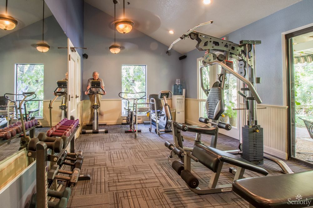 A well-equipped gym with various exercise machines and weights.