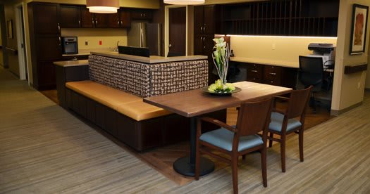 A modern dining area with a wooden table, chairs, and bench seating.