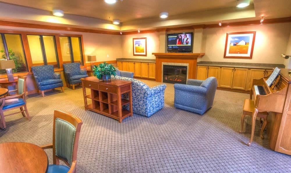 A cozy living room with comfortable furnishings and a fireplace.