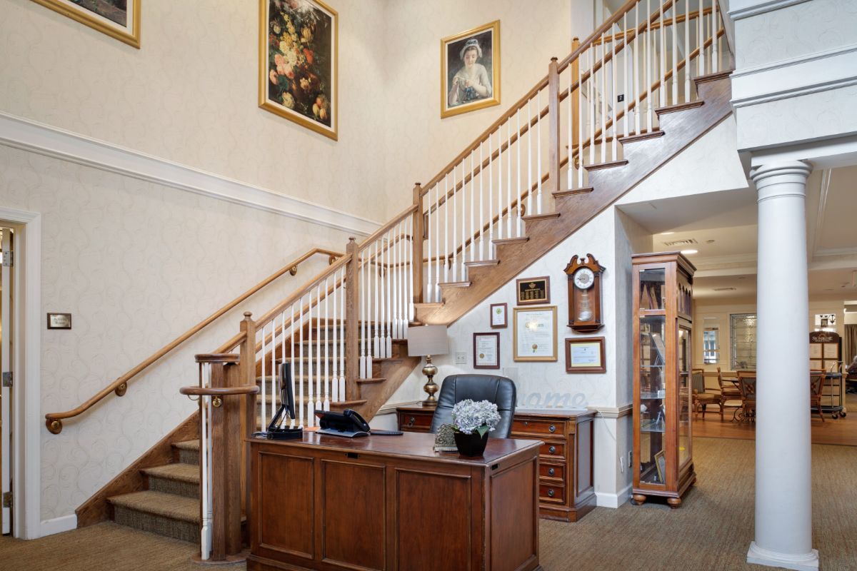 A home office with a wooden staircase and decorative elements.