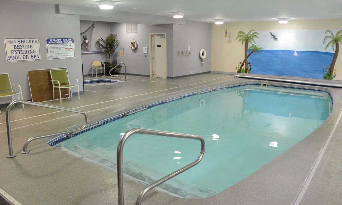An indoor swimming pool with a serene and relaxing atmosphere.