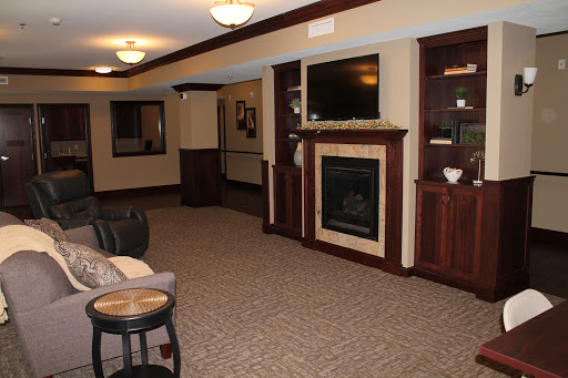 A cozy living room featuring a fireplace and comfortable furniture, designed for relaxation.