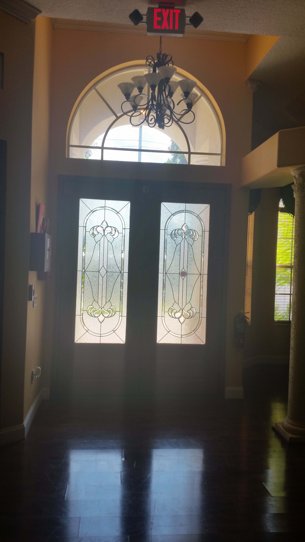 A decorative glass-paneled entrance door with intricate designs.