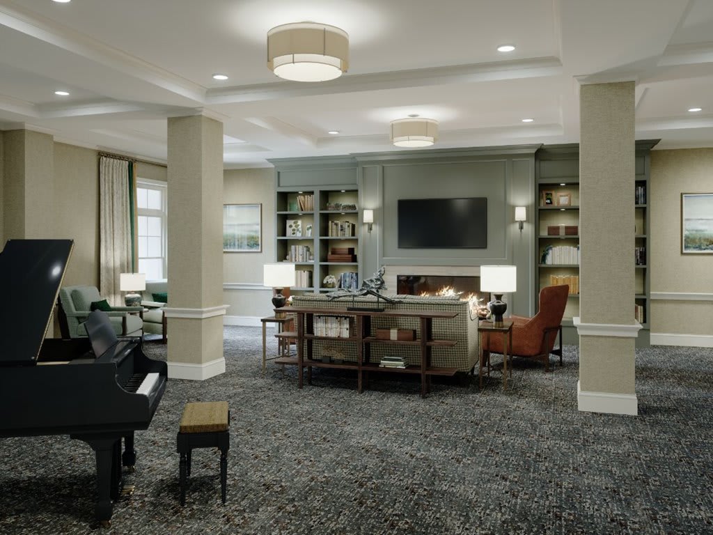 A modern living room with a piano, bookshelves, and comfortable seating.