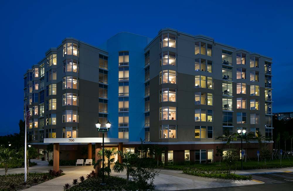 A well-lit apartment building at night.
