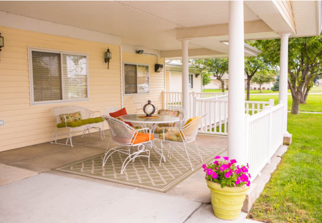 Cozy outdoor patio with comfortable seating and vibrant decor.