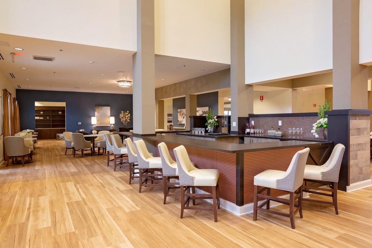 A modern hotel lobby featuring a bar area with stylish seating.