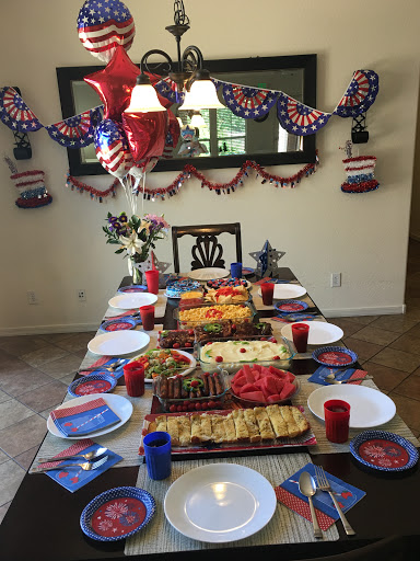 A festive table set for a patriotic celebration with delicious food and vibrant decorations.