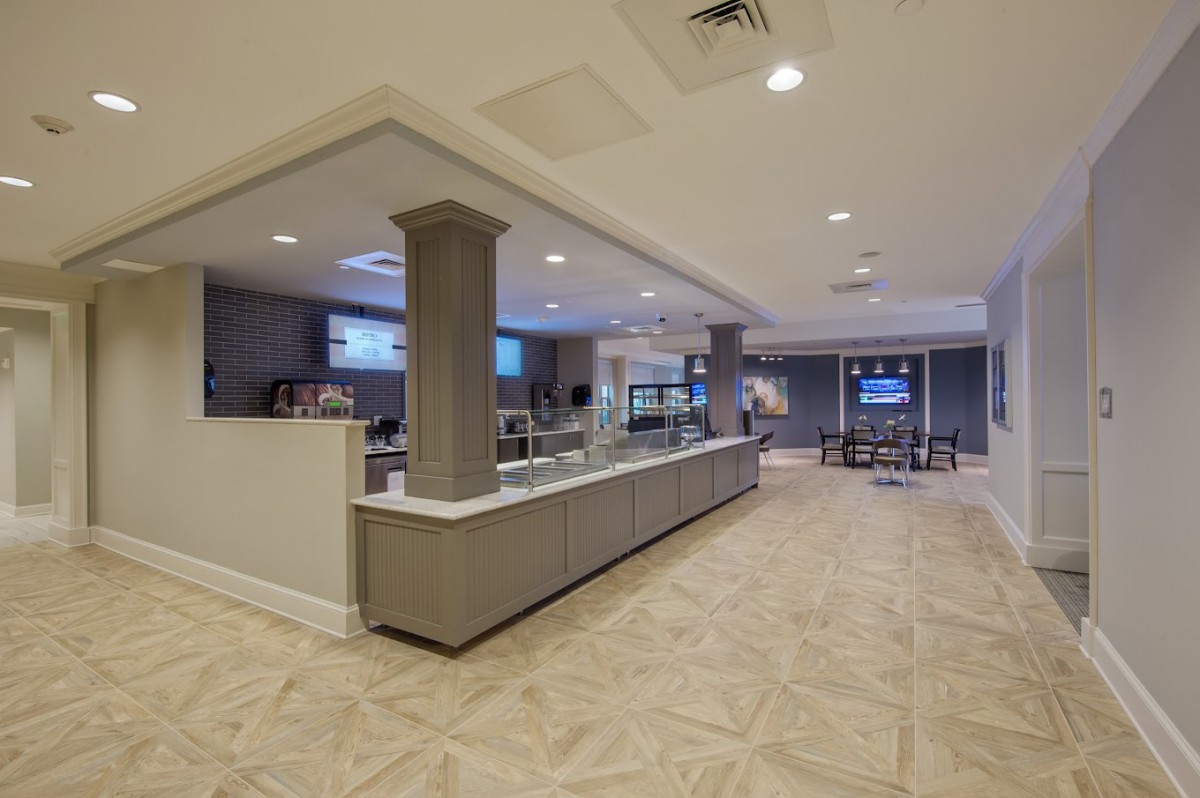 A spacious and modern hotel lobby featuring a reception desk and comfortable seating area.