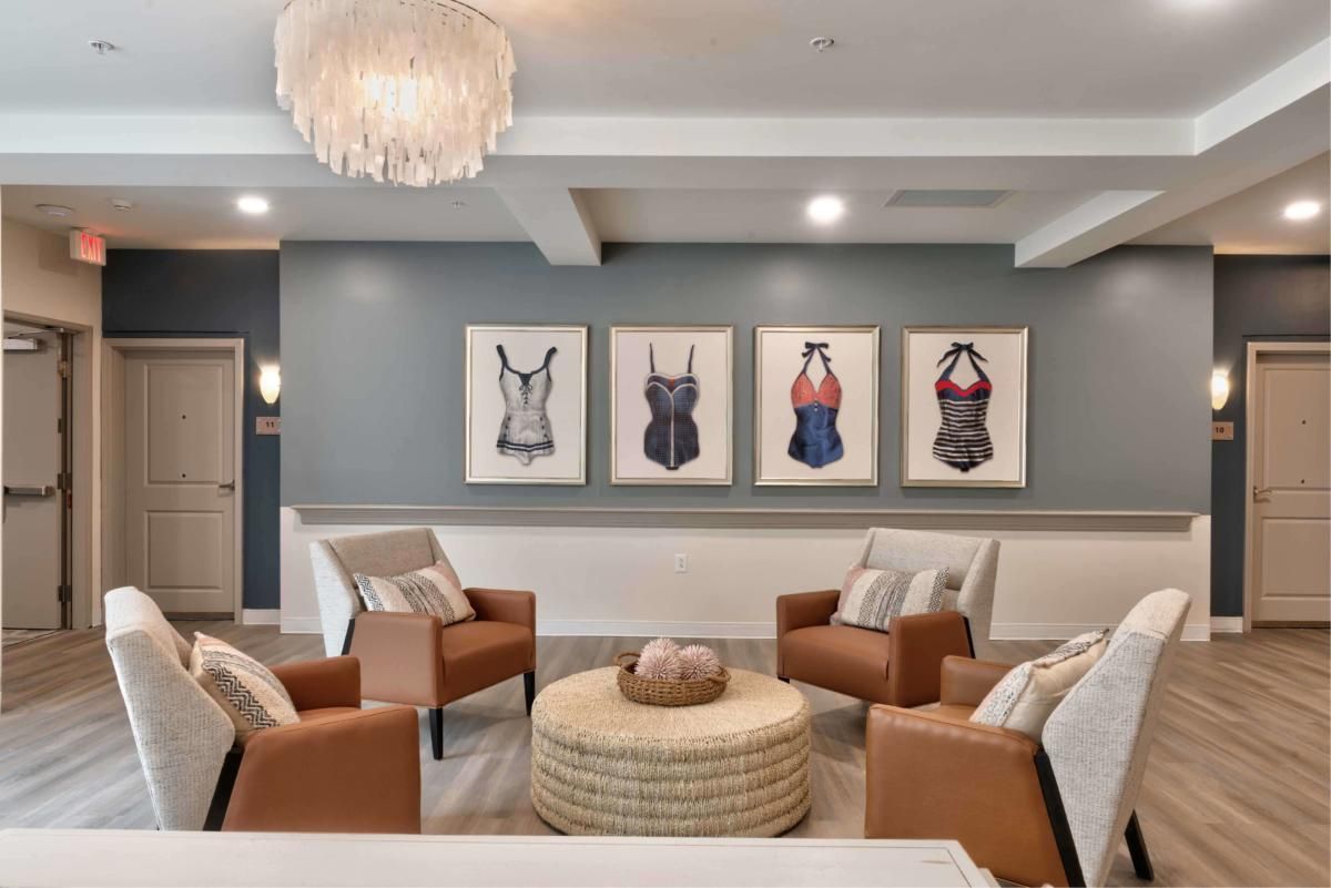 A modern living room with stylish seating and unique artwork on the wall.