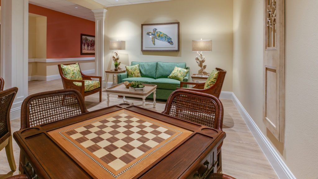 A cozy living room featuring a chessboard table and elegant furniture.