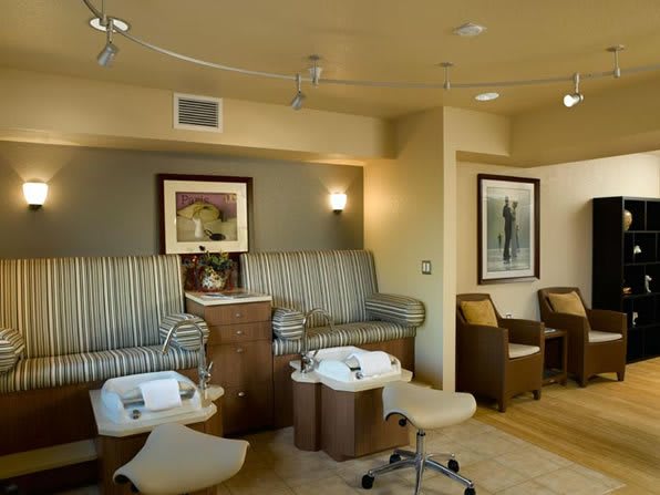 A serene spa interior featuring comfortable pedicure chairs and modern decor.