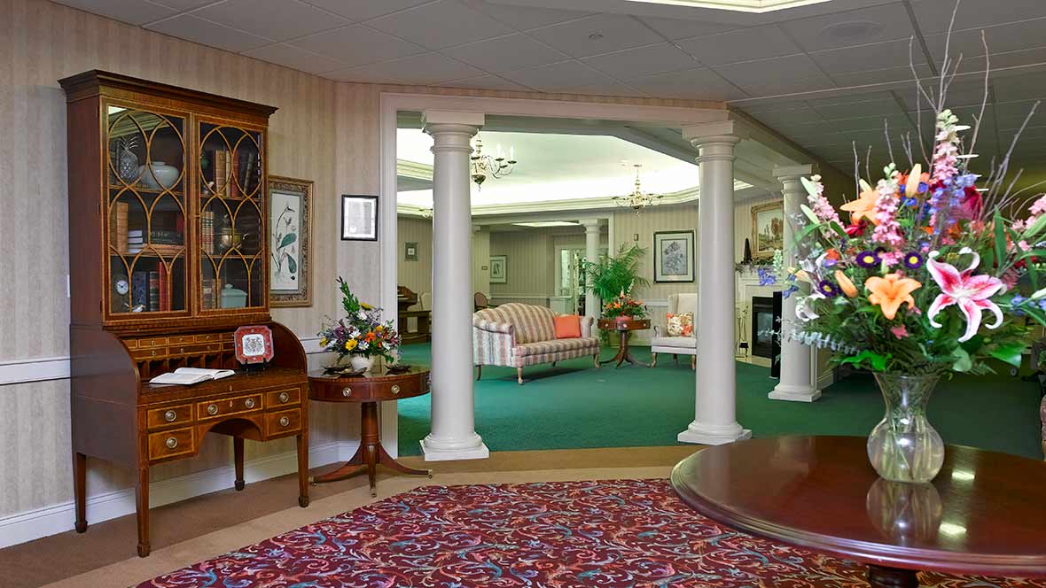 A traditionally decorated living room with columns and elegant furniture.