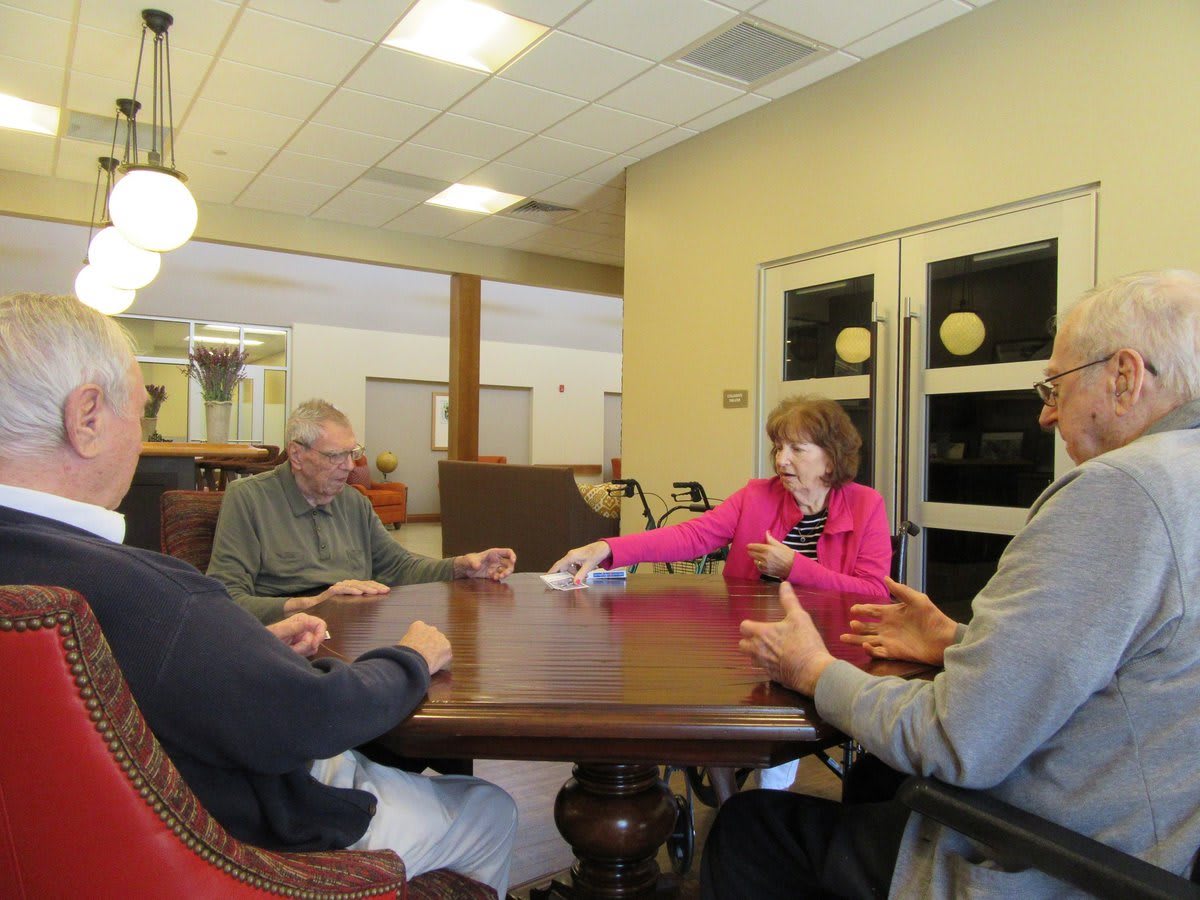 A group of people sitting around a table engaged in discussion.