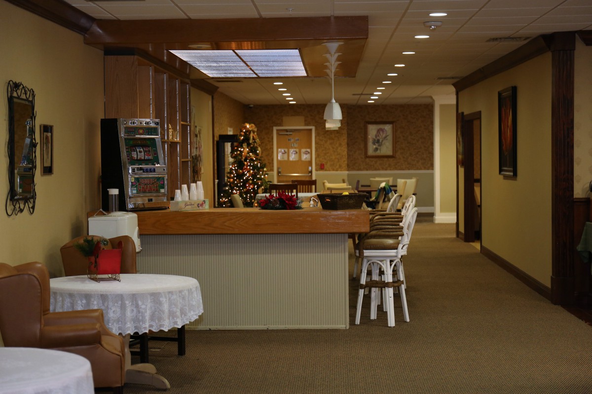 A cozy dining area with a counter and seating, softly lit for a warm atmosphere.