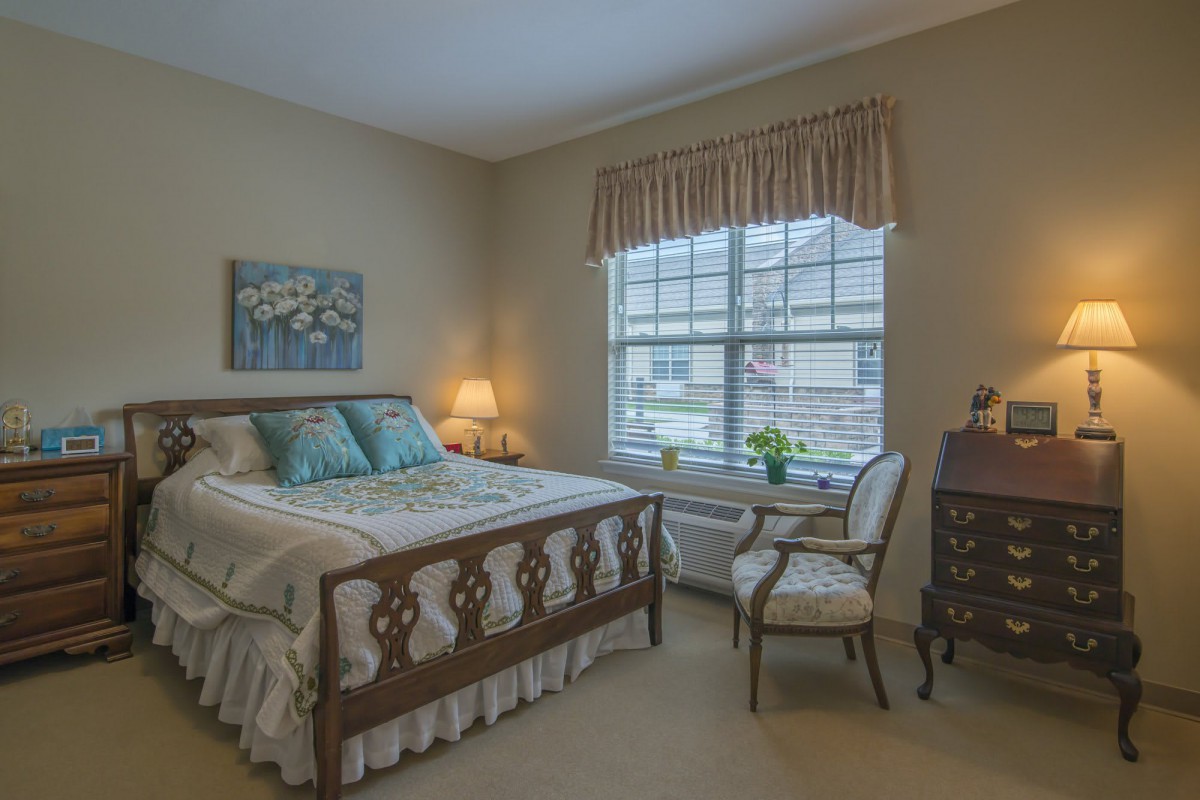 Cozy bedroom with a wooden bed frame and elegant decor.