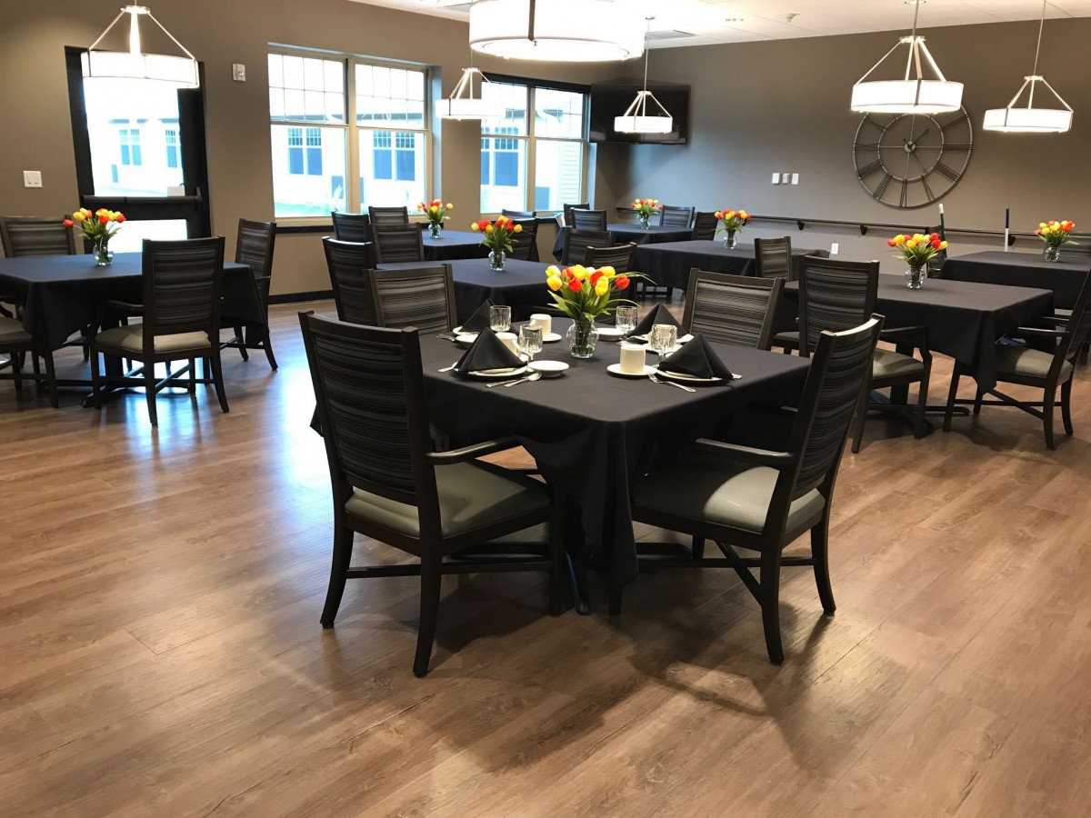 A well-arranged dining room with elegantly set tables and chairs.