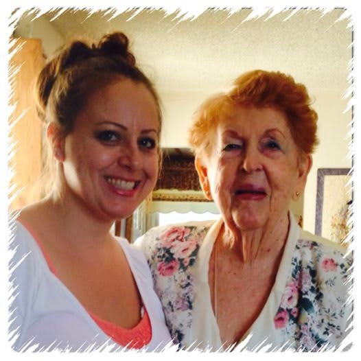 Two women smiling and posing indoors.