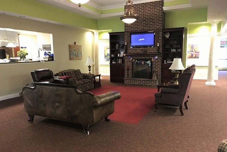 A cozy living room with a fireplace, TV, and comfortable seating.