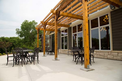 Outdoor dining area featuring a wooden pergola and stylish seating.