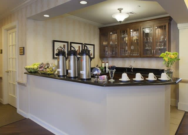 A well-organized coffee station with hot beverages and snacks.