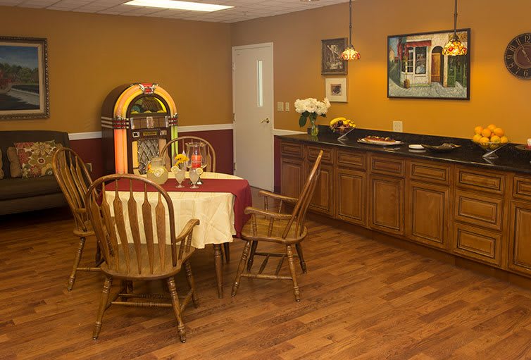 A retro-themed dining room featuring a jukebox and wooden furniture.