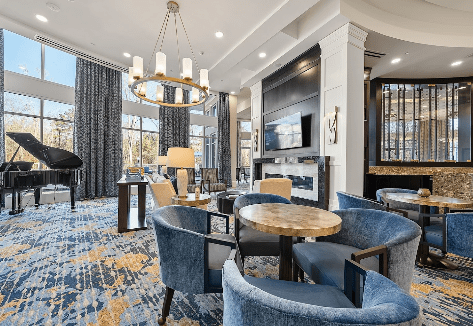 A luxurious lounge with modern seating and a stylish chandelier.