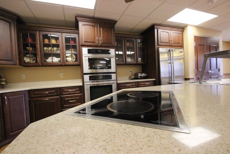 A modern kitchen interior with sleek cabinetry, built-in appliances, and a spacious countertop.