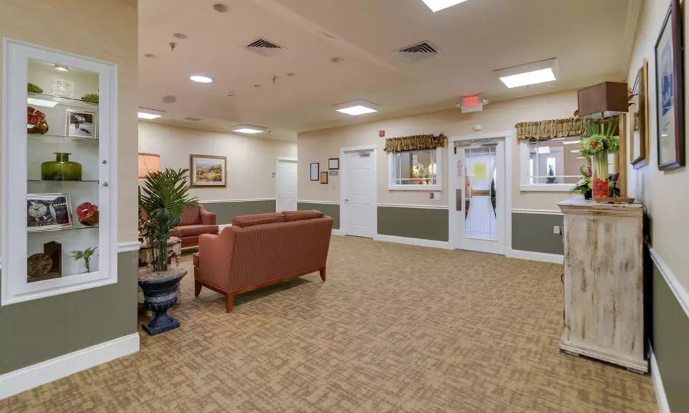 A spacious lobby with comfortable seating and decorative plants.