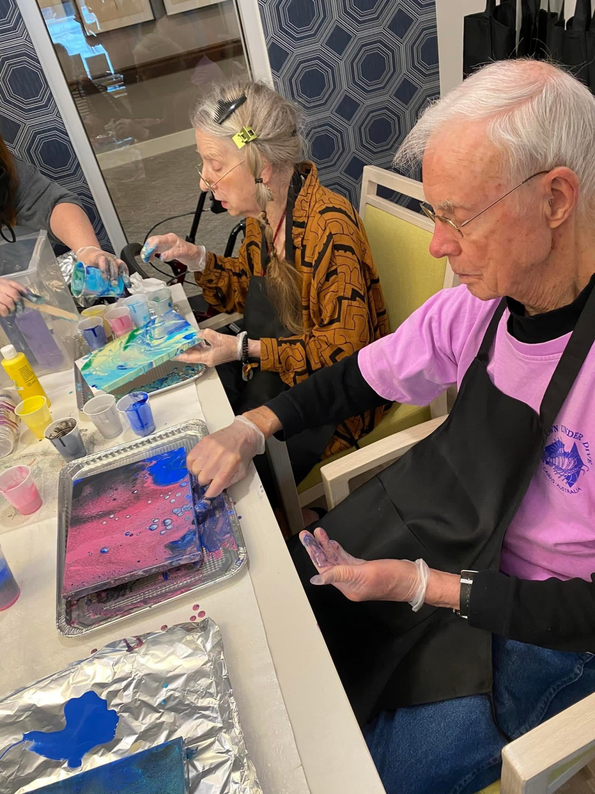 Seniors engaged in a creative painting workshop.