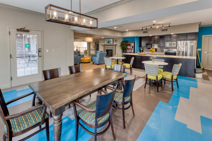Modern open-space dining and kitchen area with contemporary furniture and lighting.