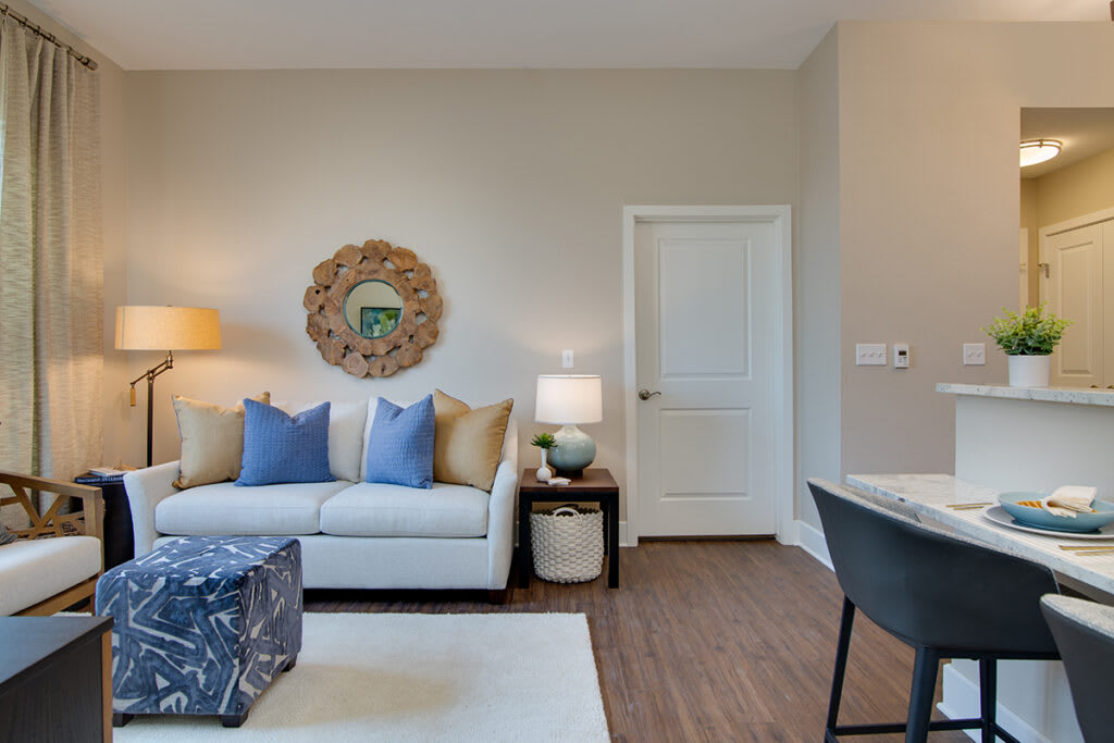 A modern living room with a comfortable sofa, decorative pillows, and warm lighting.