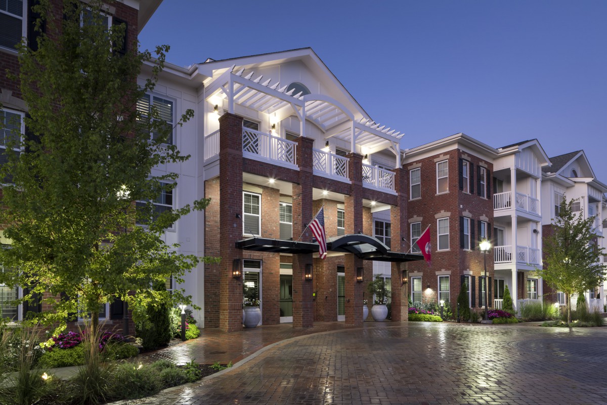 A beautifully lit hotel building with a welcoming entrance at night.